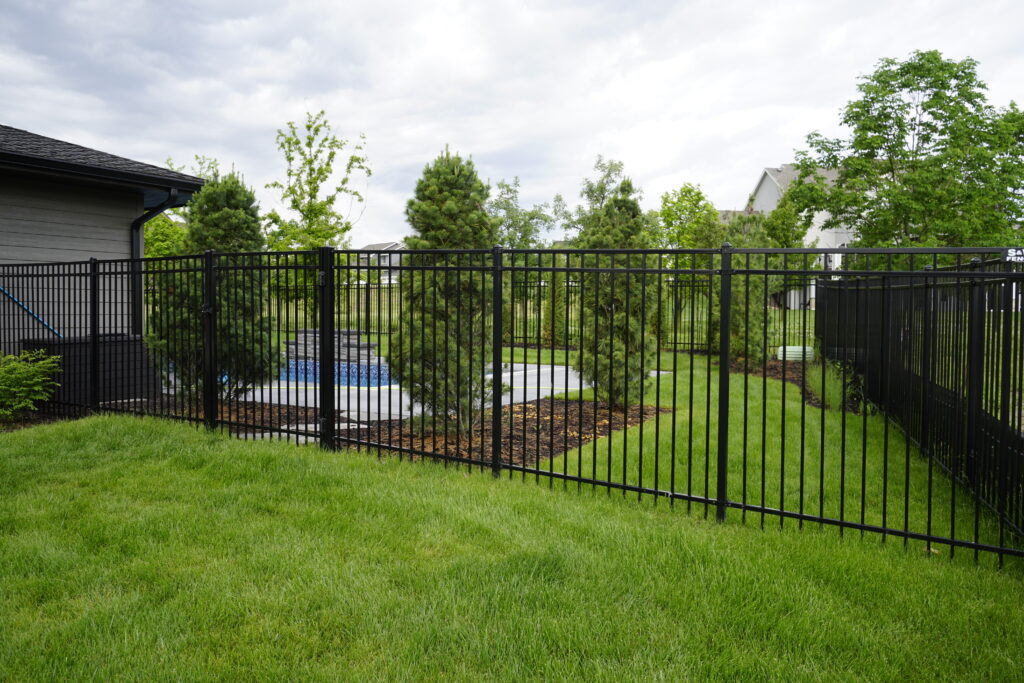 Steel fence surrounding a back yard